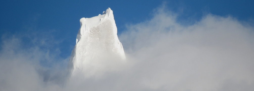 The summit of Cerro Torre peeking through the clouds, Patagonia, Argentina