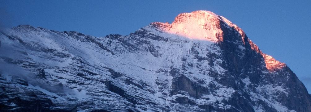 Sunrise lights the summit of the Eiger as seen from Grindelwald, Switzerland